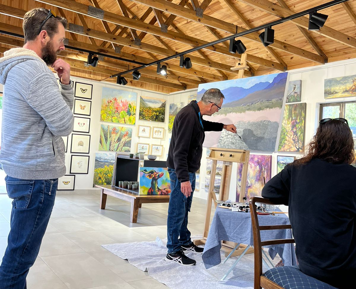 Many gallery visitors got to engage with Andrew Cooper as he painted this mountain fynbos scene at Norodhoek Art Point Gallery 